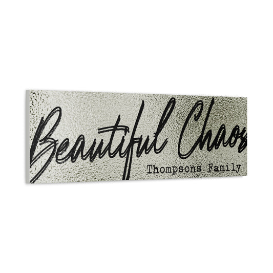 Modern minimal living room with a customized textured 'Beautiful Chaos' last name family sign on the wall against a white background side view