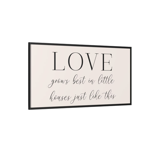 Modern living room with a 'LOVE' framed wall quote, white sofa, and decorative items side view