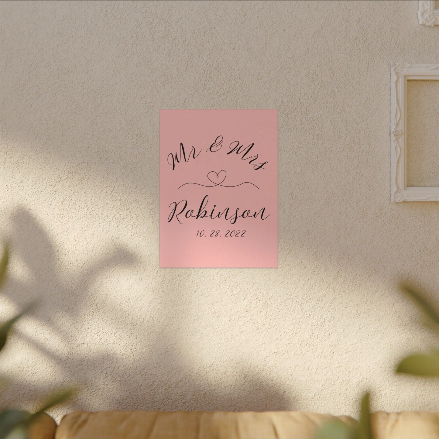 Customized minimal pink Decorative wall art with 'Mr & Mrs Robinson' on a pink background in a living room romantic gift for newly weds, anniversary and valentine's day on a living room wall