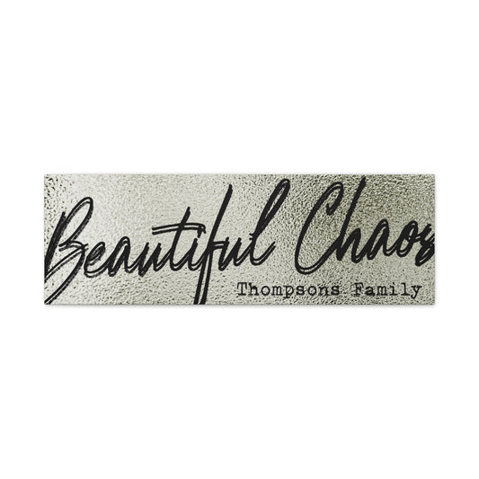 Modern minimal living room with a customized textured 'Beautiful Chaos' last name family sign on the wall against a white background front view view