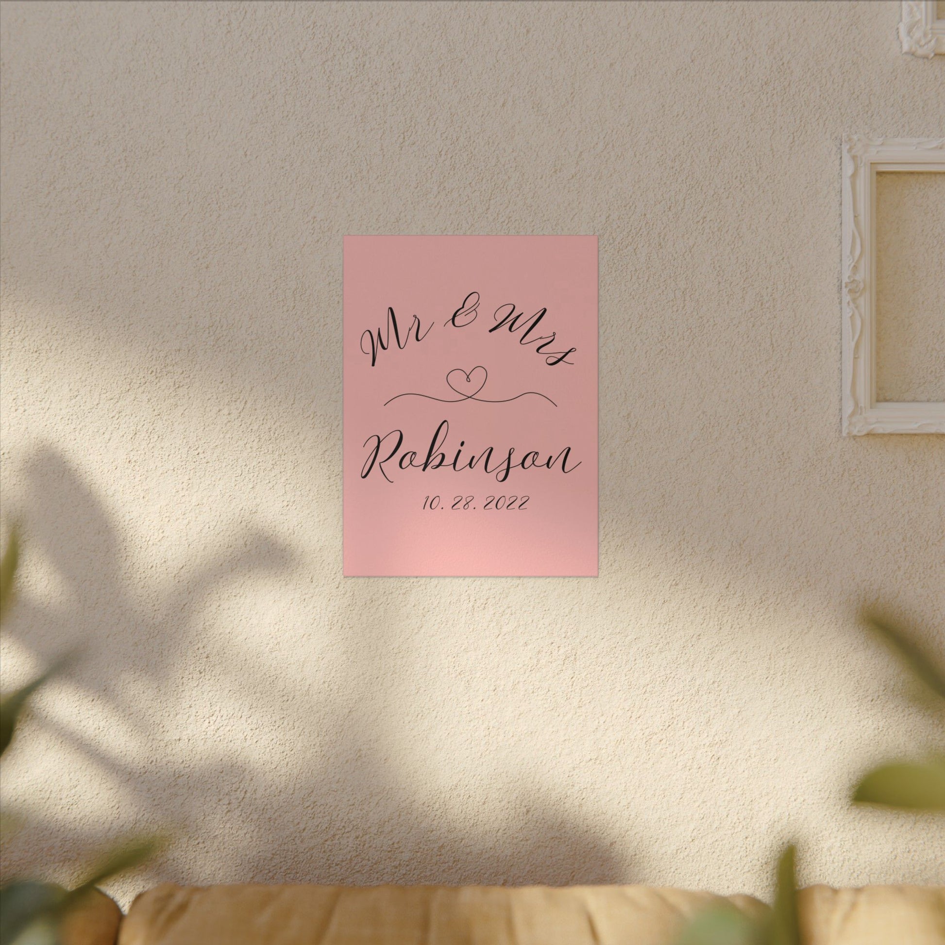 Customized minimal pink Decorative wall art with 'Mr & Mrs Robinson' on a pink background in a living room romantic gift for newly weds, anniversary and valentine's day on a living room wall